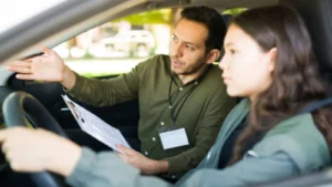 Driving examiner marking learner driver mistakes during practical driving test in car