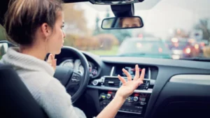Learner driver stalling car at traffic light during driving test practice