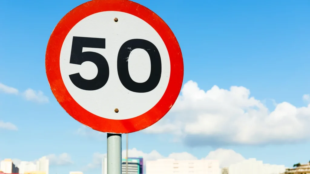A realistic image of a U.S. highway showing a speed limit sign.
