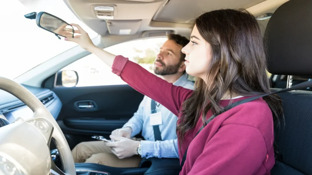 Beginner driver practicing safe driving techniques with a supervising driver on a United States .