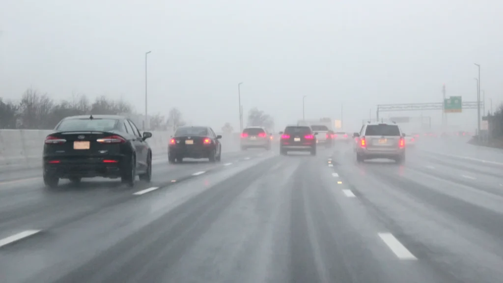 Cars maintaining a safe following distance on a United States highway using the 3 second rule.