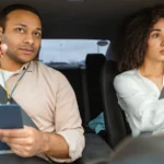 Driving Instructor Teaching Young Woman in Car