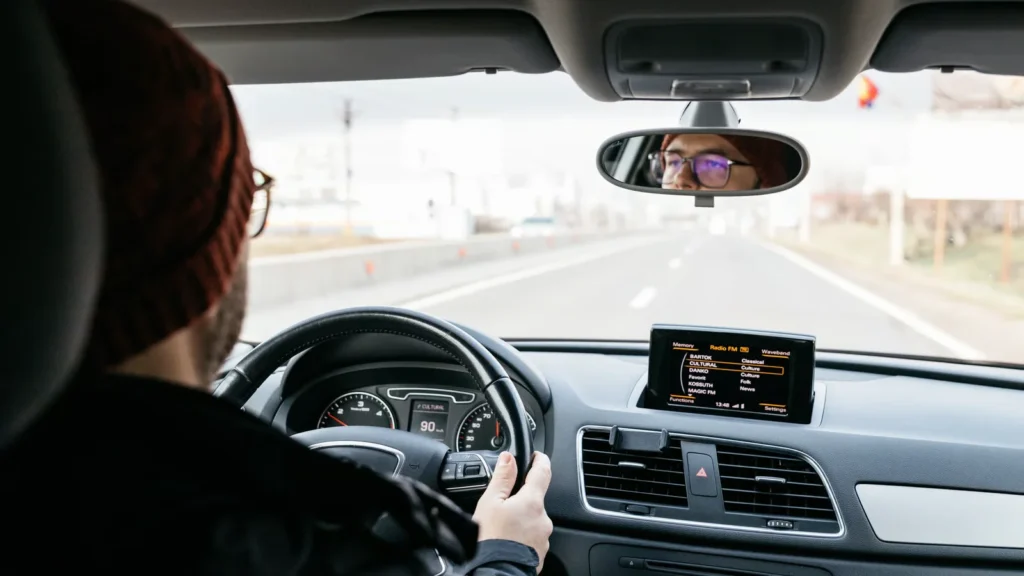 A skilled driver driving during the day and following fundamental driving rules—skills every new driver must master.